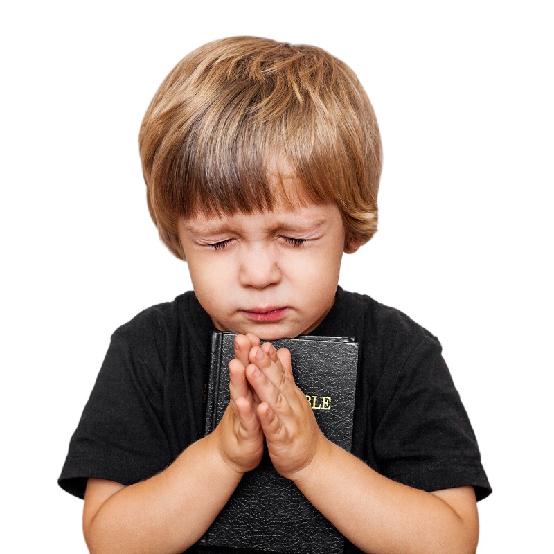 Little boy praying with the Bible in hand